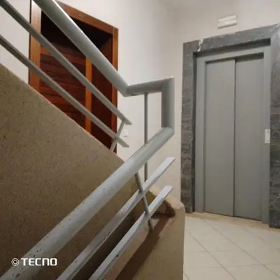 a set of stairs in a building with a door at Hébergement en lit dans chambre et salle de bain partagées pour Hommes in Rabat