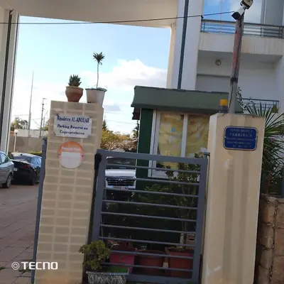 a door to a building with a sign on it at Hébergement en lit dans chambre et salle de bain partagées pour Hommes in Rabat