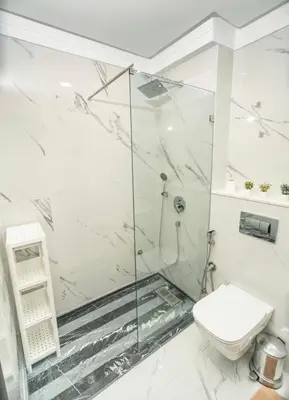a white bathroom with a shower and a toilet at residence living housse in Casablanca