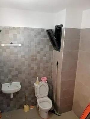a bathroom with a toilet and a sink at A beautiful apartment for you in Rabat