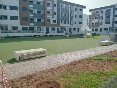 a park in front of a building with a bench at A beautiful apartment for you in Rabat