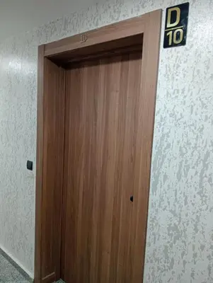 a wooden door with a sign on top of it at A beautiful apartment for you in Rabat