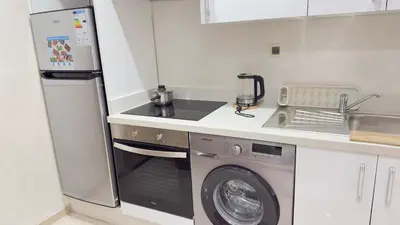 a small kitchen with a washer and dryer at Casablanca Center Studio Karachi 33 in Casablanca