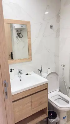 a white bathroom with a sink and a toilet at Casablanca Center Studio Karachi 33 in Casablanca