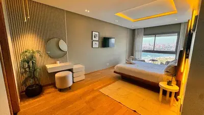 a bedroom with a bed and a large window at Panoramic sea view high speed wi-fi central in Casablanca