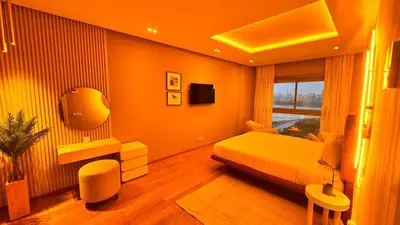 a bedroom with a bed and a television in it at Panoramic sea view high speed wi-fi central in Casablanca