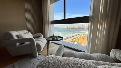 a living room with a view of the ocean from a window at Panoramic sea view high speed wi-fi central in Casablanca