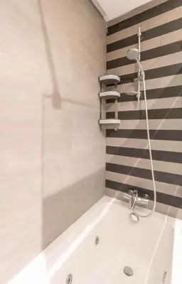 a bath tub with a shower in a bathroom at Panoramic sea view high speed wi-fi central in Casablanca