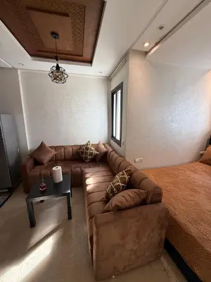 a living room with a couch and a bed at La garonne in Casablanca