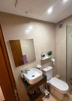 a bathroom with a sink and a toilet and a mirror at La garonne in Casablanca