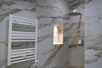 a bathroom with a marble wall and a light at Premium Studio near Agdal Train Station in Rabat
