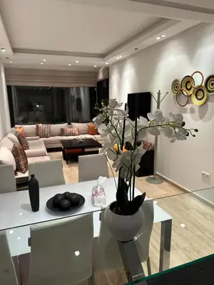a living room with a white table with a vase of flowers at 9 Rue d'Alger Casablanca in Casablanca