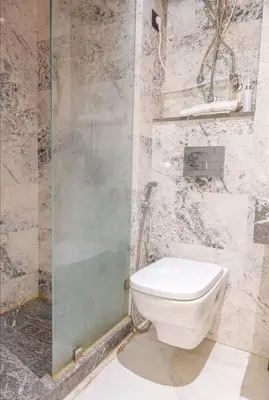 a bathroom with a toilet and a glass shower at Super Summit Apartments Le Phenix in Casablanca
