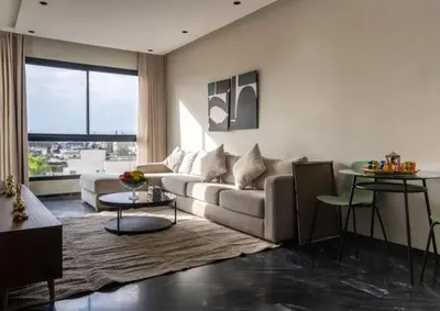 a living room with a couch and a table at Super Summit Apartments Le Phenix in Casablanca