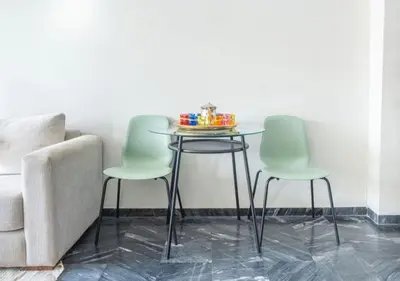 a table with chairs and a bowl of toys on it at Super Summit Apartments Le Phenix in Casablanca