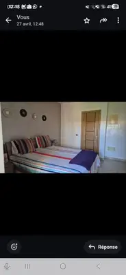 a picture of a bedroom with a bed at Appartement en front de mer in Sidi el Haj Bou Derbala