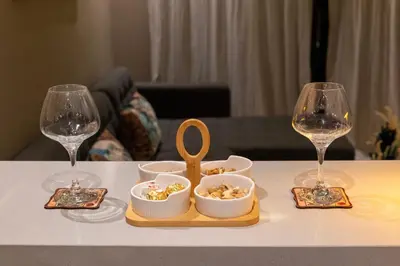 a table with two wine glasses and a tray of food at Studio Joudia in Casablanca