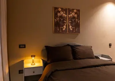 a bedroom with a bed and a picture on the wall at Studio Joudia in Casablanca