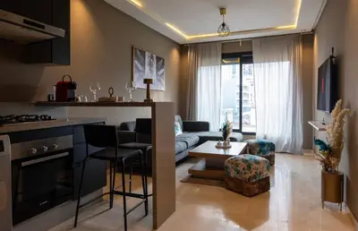 a kitchen and living room with a couch and a table at Studio Joudia in Casablanca