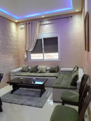 a living room with a couch and a coffee table at Magnifique T2 à Skhirat in Skhirat