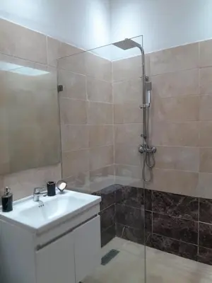 a bathroom with a sink and a shower at Magnifique T2 à Skhirat in Skhirat