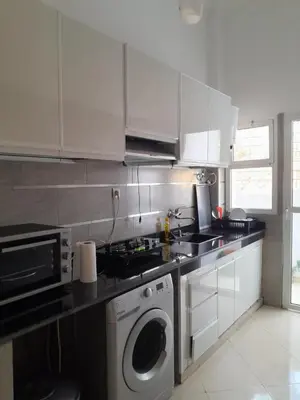 a kitchen with a washing machine and a washer at Magnifique T2 à Skhirat in Skhirat