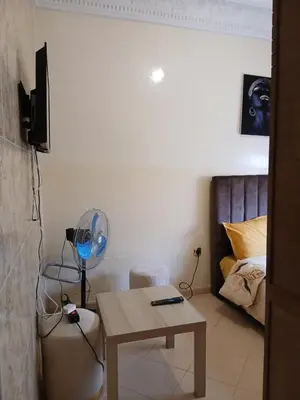 a room with a table with a fan and a bed at Cambre à louer in Casablanca
