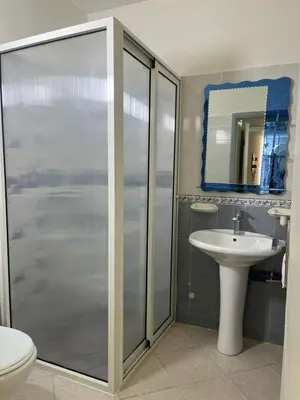 a bathroom with a shower and a sink at Appartement lumineux en plein coeur de harhoura in El Harhoura