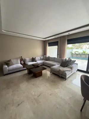 a living room with a couch and a table at Appartement de luxe in Casablanca