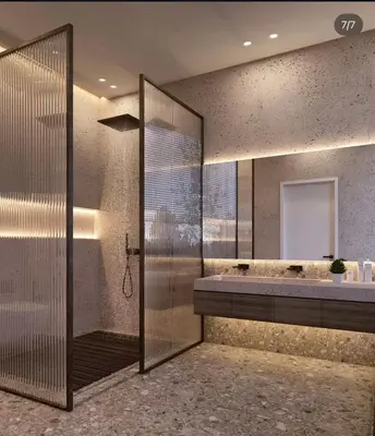 a bathroom with a shower and a large mirror at Appartement de luxe in Casablanca