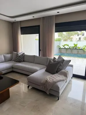 a living room with a couch and a table at Appartement de luxe in Casablanca