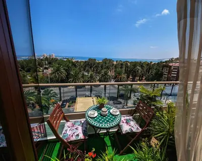 a balcony with a table and chairs and a view of the ocean at Beachfront View Appartement in Mohammedia