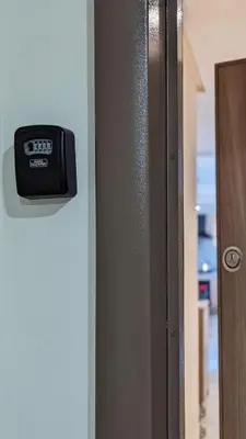 a clock is on the side of a door at Beachfront View Appartement in Mohammedia