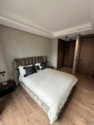 a bedroom with a large white bed with two pillows at Charming 1-bedroom apartment, Casablanca Finance City in Casablanca