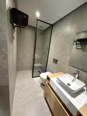 a bathroom with a toilet and a sink and a shower at Charming 1-bedroom apartment, Casablanca Finance City in Casablanca