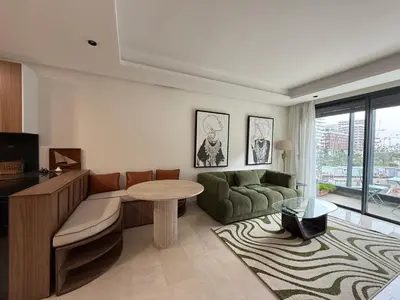 a living room with a couch and a table at Charming 1-bedroom apartment, Casablanca Finance City in Casablanca