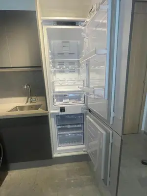 an empty refrigerator with its door open next to a sink at Studio à louer in Casablanca