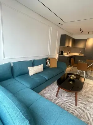 a blue couch in a living room with a table at Studio à louer in Casablanca