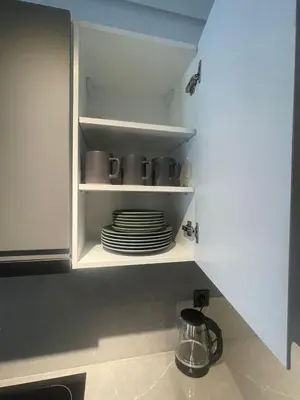 a cupboard with a stack of plates in it at Studio à louer in Casablanca