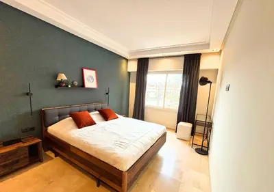 a bedroom with a bed and a window at Grand Studio Moderne au Centre, Parking Privé in Casablanca