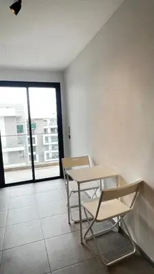a table and two chairs in a room with a window at La Perle - Luxe & élégance Face à la gare Agdal in Rabat