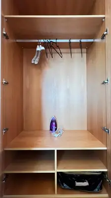 a closet with wooden shelves and a purple toy at La Perle - Luxe & élégance Face à la gare Agdal in Rabat