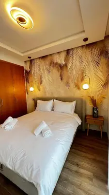 a bedroom with a white bed with two towels on it at La Perle - Luxe & élégance Face à la gare Agdal in Rabat