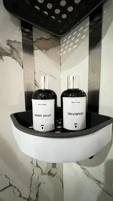 two black and white bottles on a shelf at La Perle - Luxe & élégance Face à la gare Agdal in Rabat