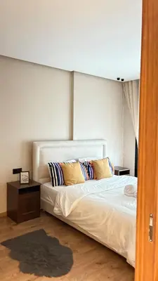 a bedroom with a white bed with pillows on it at stylish studio located in centre of casablanca in Casablanca
