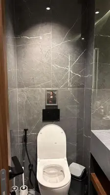 a bathroom with a toilet with a picture on the wall at stylish studio located in centre of casablanca in Casablanca