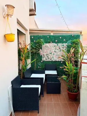 a balcony with tables and chairs and flowers at Modern Chic Studio avec Terrace privée et Vue Sans Vis-a-vis et Parking privé in Casablanca