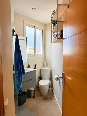 a bathroom with a toilet and a sink and a window at Modern Chic Studio avec Terrace privée et Vue Sans Vis-a-vis et Parking privé in Casablanca