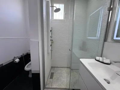a bathroom with a shower and a toilet and a sink at Palais Elya in Rabat