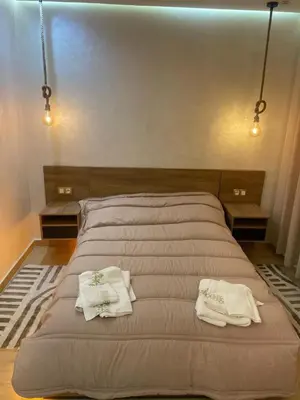 a large bed with two white towels on it at Studio Chic & Neuf au Cœur de Bourgogne in Casablanca-Port
